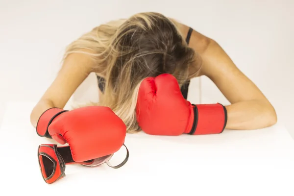 woman with red boxing gloves and red shoes defending