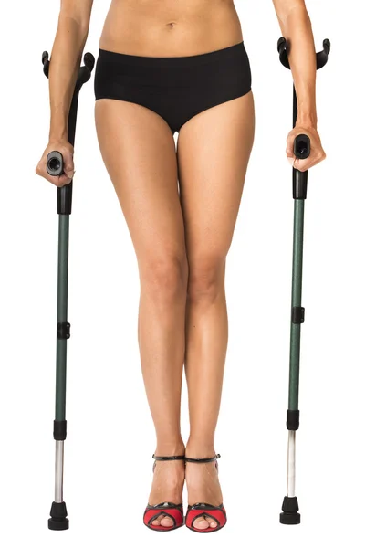 Woman with red high shoes on crutches Royalty Free Stock Photos