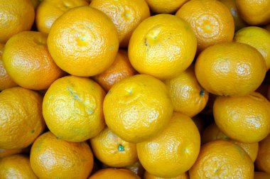 heap of yellow ripe tangerines