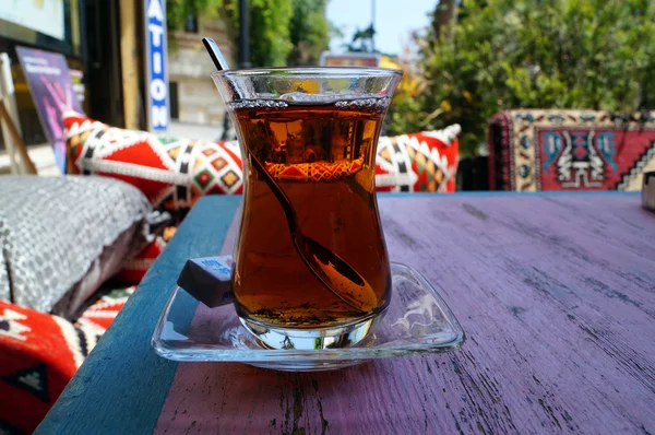 Красный турецкий чай с сахаром на фоне яркой подушки — стоковое фото