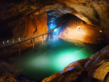 Yeni Athos şehrindeki mağara, sarkıtlar, dikitler, dikitler ve göl üzerinde bir köprü, Abhazya..