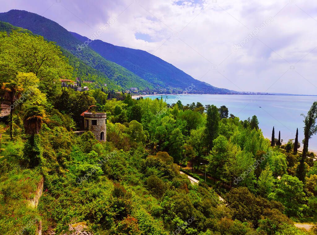 View from the balcony of the abandoned Prince of Oldenburg castle in the city of Gagra on the embankment, the beach and the Black Sea, Abkhazia.