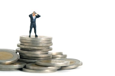 Para yığınının üzerinde duran dürbün kullanan iş adamları. Minyatür minyatür insanlar fotoğraf çekmeyi sever. beyaz arkaplanda izole