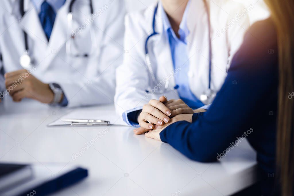 Unknown woman-doctor reassuring her female patient, close-up. Two physicians consulting and giving some advices to woman. Concepts of medical ethics and trust. Empathy in medicine