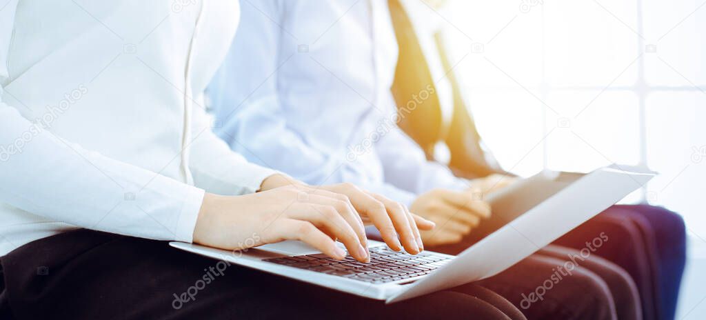 Group of diverse business people working in office, close-up. Woman working with laptop. Conference, meeting or training concepts