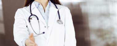 Kimliği belirsiz genç kadın doktor elini sıkmak ya da hayat kurtarmak için yardım eli uzatıyor. Coronavirus salgını sırasında ilaç konsepti. Covid 2019