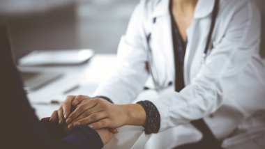 Bilinmeyen kadın doktor, kadın hastasına güvence veriyor, yakın plan. Doktor bir kadına danışmanlık yapıyor ve tavsiyelerde bulunuyor. Tıbbi ahlak ve güven kavramları. Tıpta empati