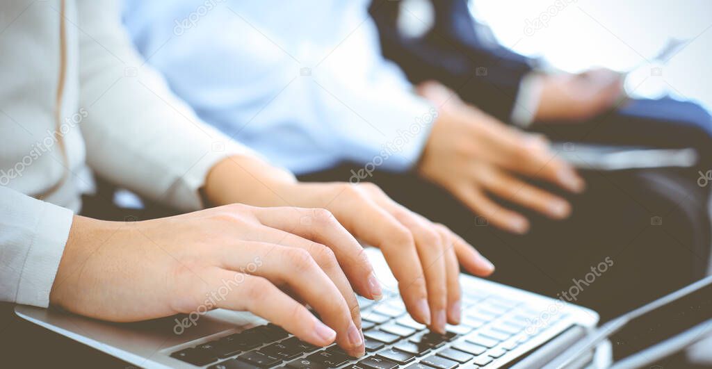 Group of business people working in office, close-up. Businesswoman working with laptop. Conference or training concepts