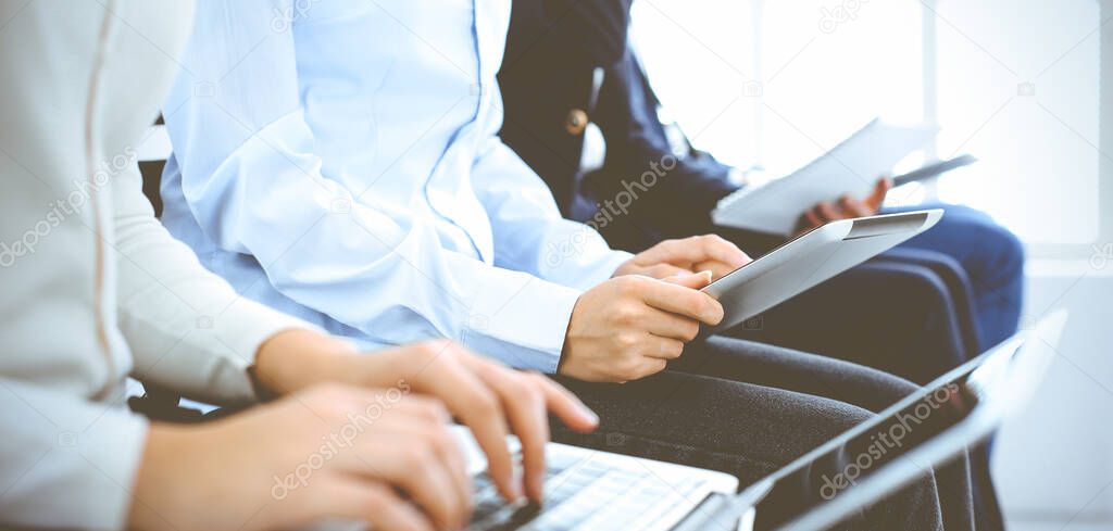 Group of business people working in office, close-up. Businesswoman working with laptop. Conference or training concepts