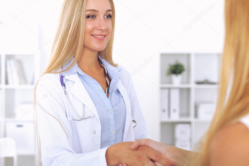 Confident doctor looking at  patient while speaking to her