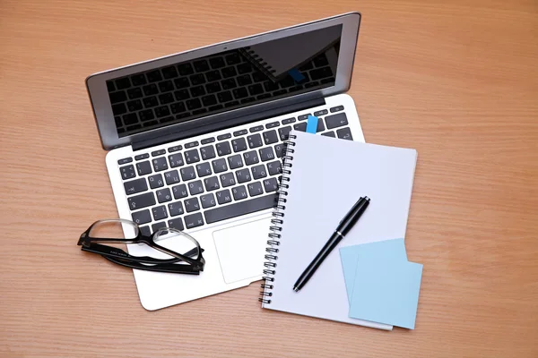 Office table with laptop, notepad. View from above with copy space