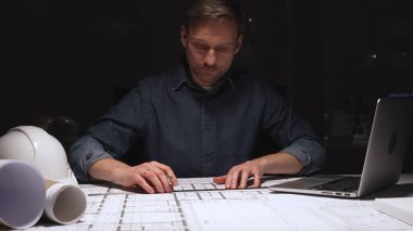 Mimari, profesyonel inşaat planlarını ve mühendislik planlarını geliştiriyor, özenle çiziyor, akşam saatlerinde üretken kalıyor.