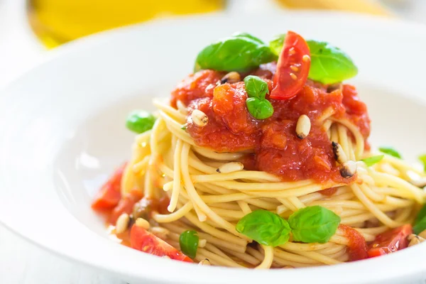 Spagetti domates ve fesleğen yaprakları ve biber ile