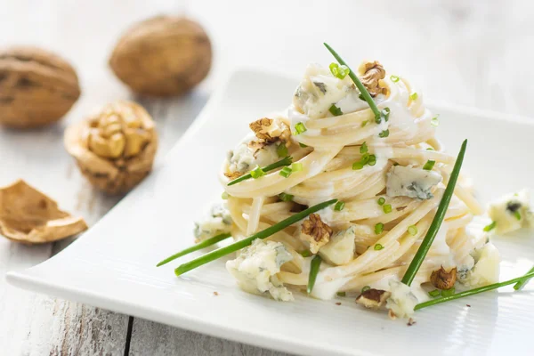 Pasta with gorgonzola on a wooden background — Stock Photo, Image