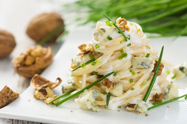 Pasta with gorgonzola on a wooden background — Stock Photo, Image