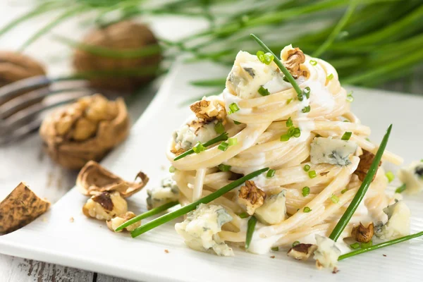 Pasta with gorgonzola on a wooden background — Stock Photo, Image