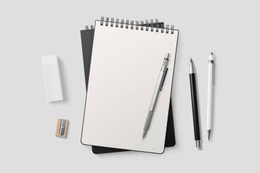 Gerçek fotoğraf, spiral kaplı model şablon, açık gri arka planda izole edilmiş siyah kağıt kapaklı. Yüksek çözünürlük.