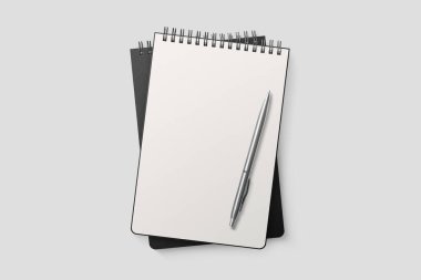 Gerçek fotoğraf, spiral kaplı model şablon, açık gri arka planda izole edilmiş siyah kağıt kapaklı. Yüksek çözünürlük.