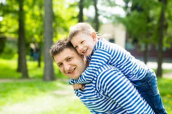 Father and son in the park on a sunny summer day — Stock Photo, Image