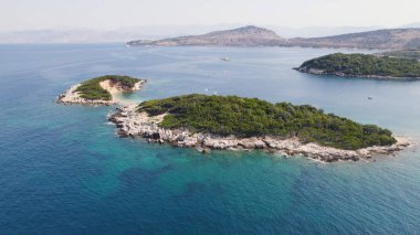 Aerial perspective of Ksamil Albania showing small islets in turquoise waters along the coastline