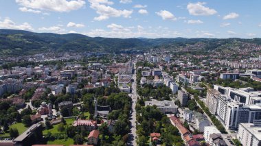 Aerial drone view of Banja Luka showing urban buildings, streets, and city skyline from above