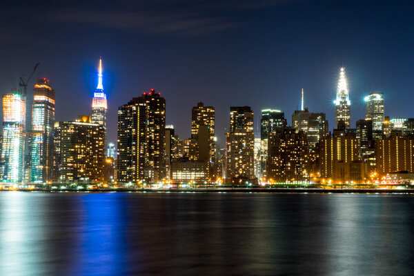 Manhattan skyline in New York City at night from across the East River