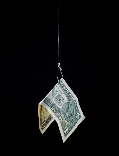 Dinero colgando de un anzuelo Imagen de archivo