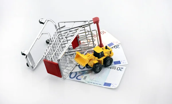 Conceptual studio shot of a bunch of euro banknotes filling a shopping cart on white background — Stock Photo, Image