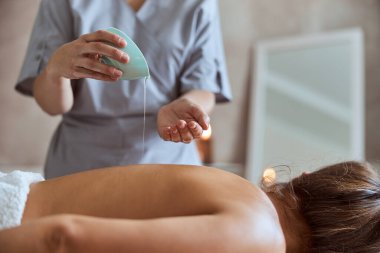 Masaj salonundaki genç çekici kadın güzellik ve sağlık prosedürleri uyguluyor.