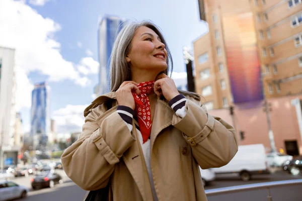 Mature pale hair stylish woman lifestyle portrait outdoors in city