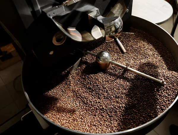 Coffee processing. Roastery, roasting machine and fresh beans