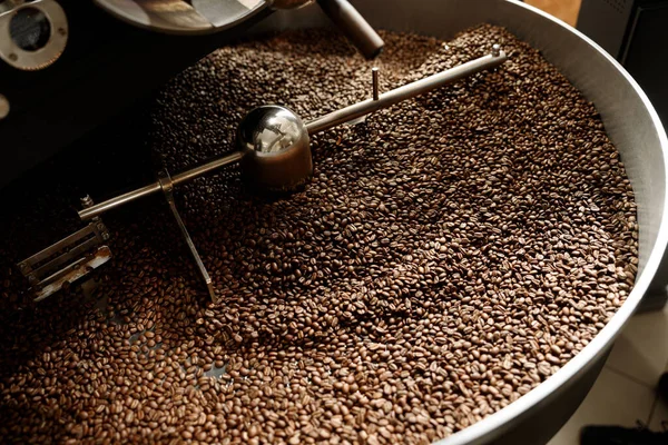 Coffee processing. Roastery, roasting machine and fresh beans