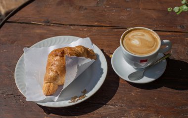 croissant and coffe for breakfast in Italian bar