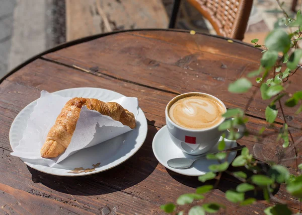 croissant and coffe for breakfast in Italian bar