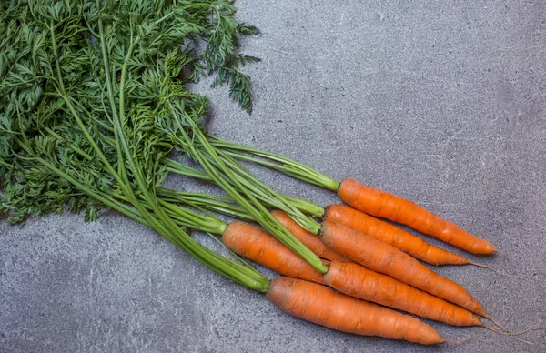 Fresh carrot on the stone background — Stock Photo, Image