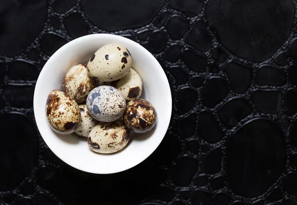 Eggs of quail on the black background — ストック写真