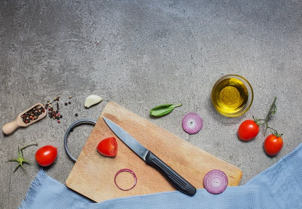 Tomatoes, onion and olive oil on grey stone background — Stock Photo, Image