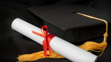 Mezuniyet şapkası ve diploması siyahlara yakın.