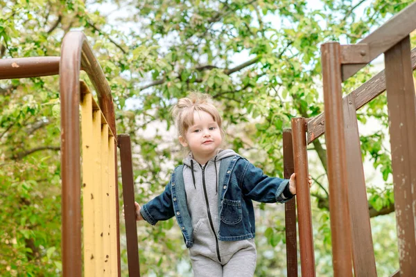 Happy little toddler girl on the playground.Childrens games in park outdoors.Childhood joy and happiness — Stock Photo, Image