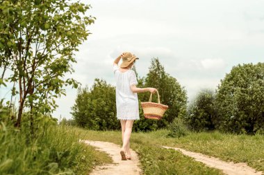 spring day. happy woman turned away back, spring day.lovely girl, denim jacket, yellow field. field yellow bouquet. sunny summer day. freedom and dream. in love and gentle shy
