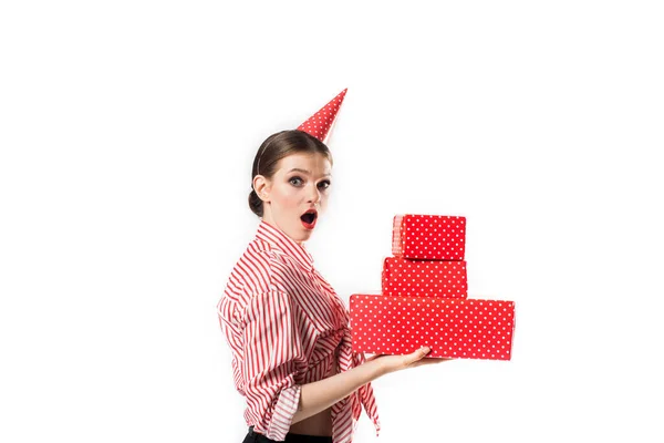 Večírek nebo narozeniny. Emocionální krásná dívka v červeném s velkými dárkovými krabicemi. Izolovat na bílém ve studiu. Překvapení a radost, smích a výkřiky — Stock fotografie