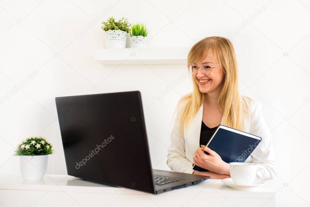 Female lawyer giving consultation online at home. Young girl student at a laptop. Online counseling, online education, distance learning. Tax advice to lawyer or accountant