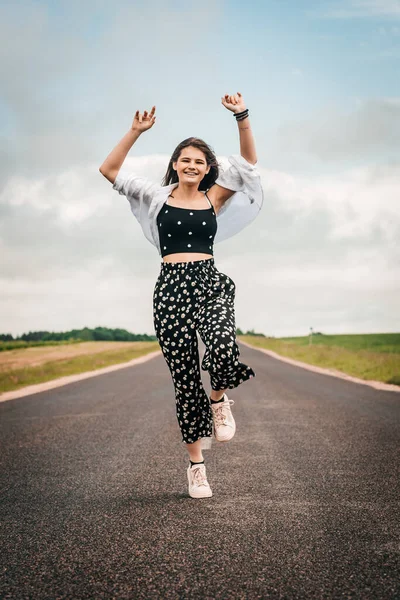 teenager girl dancing on the road. freedom generation z