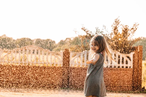 Um bebé feliz a sorrir. menina correndo ao pôr do sol ao ar livre — Fotografia de Stock