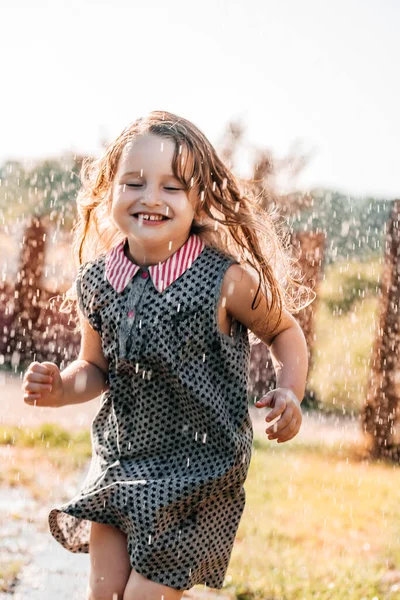 Feliz bebé sonriendo. niña corriendo al atardecer al aire libre — Foto de Stock