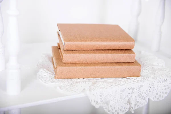 White shelves in retro style with beige book — Stock Photo, Image