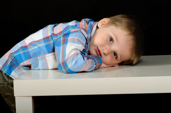 An unusual portrait of a beautiful blond boy