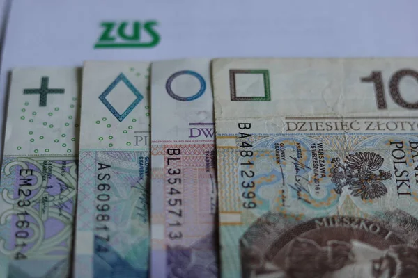 ZUS Sosyal Güvenlik Kurumu logosu artı para ve paralar.