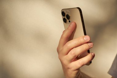 Turku, Finland- 26 Eylül 2021: yeni akıllı telefon iPhone 13 profesyonel altın rengi bir adamın elinde