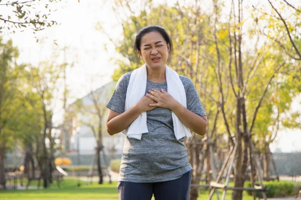 Old Asian people suffer from exercise pain. Senior woman having heart attack